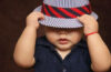 baby with blue cap